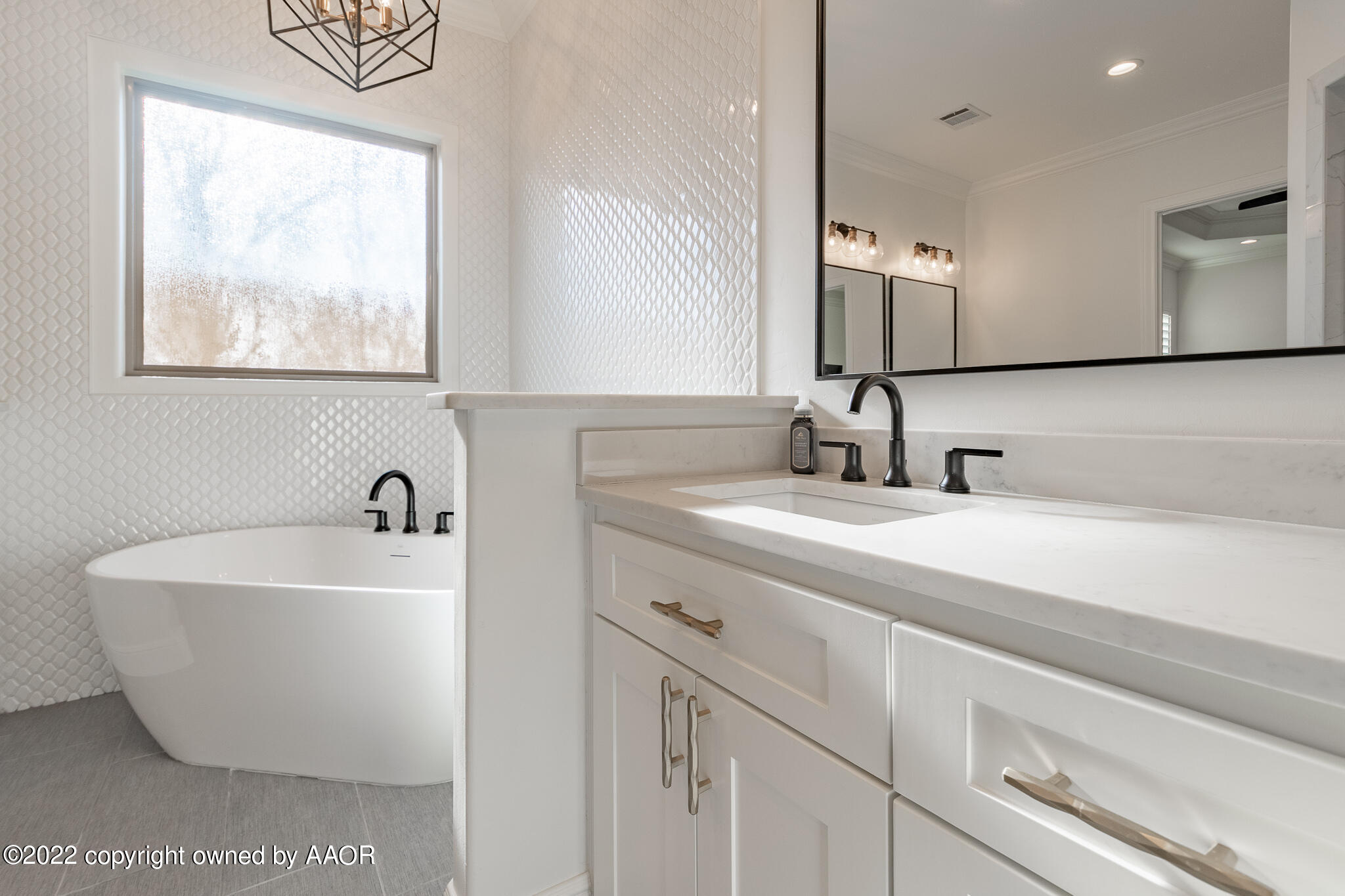8406 Georgetown Drive Amarillo, TX 79119 - Photo 21 of 43 a bathroom with a sink and a mirror