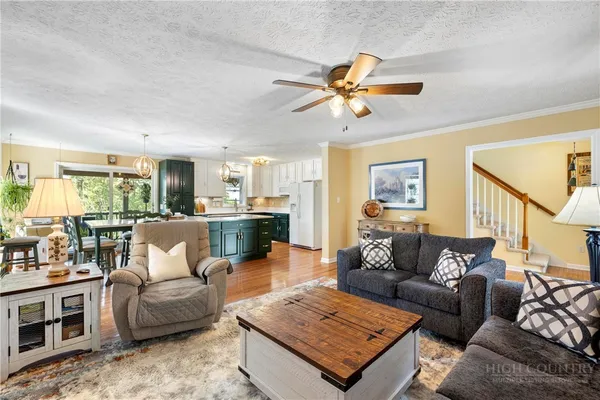 a living room with furniture and kitchen view