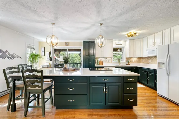 a kitchen with a sink cabinets and wooden floor
