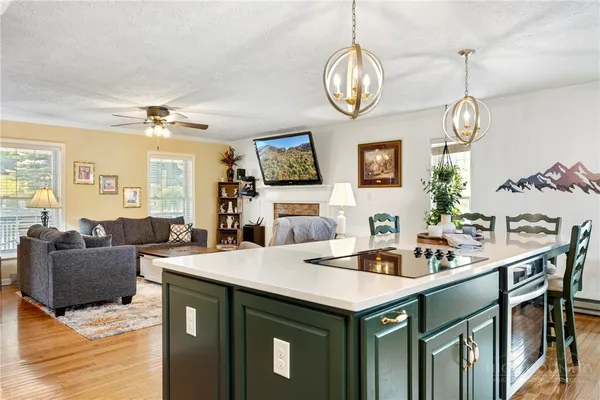 a view of kitchen island a sink and living room view