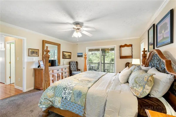 a bedroom with a bed a window and dresser