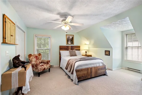 a spacious bedroom with a bed and a chandelier