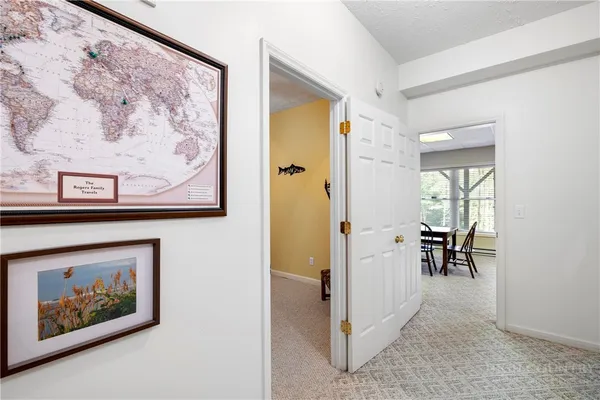 a view of a hallway view with furniture and front view of a house