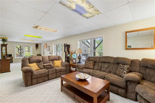a living room with furniture and a ceiling fan