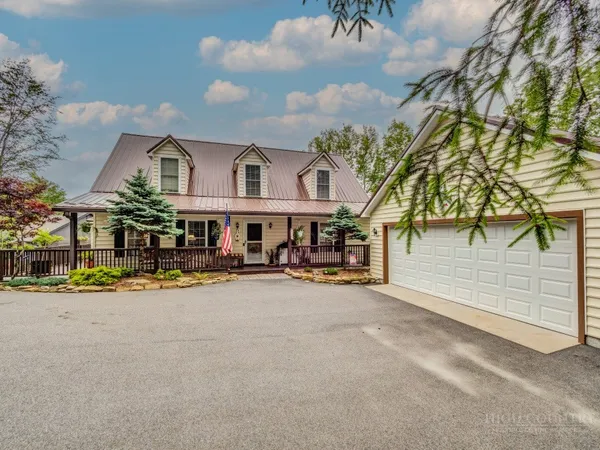 an outdoor view of house with yard and outdoor seating