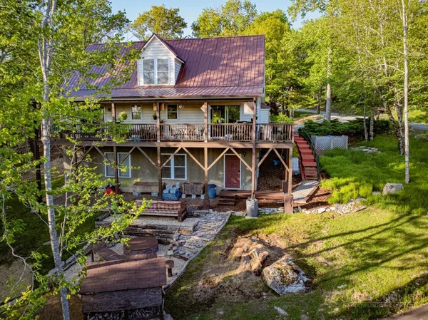 a view of a chairs and table in a backyard