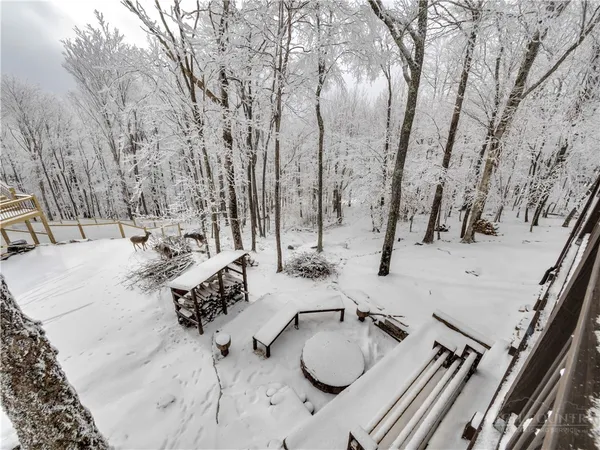 a view of roof deck with chairs and couches