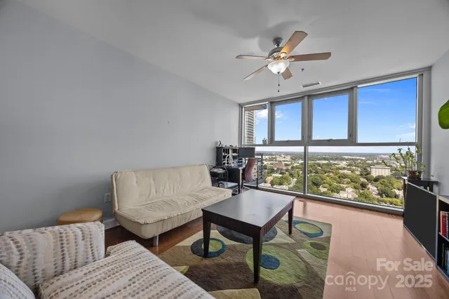 a living room with furniture and a large window