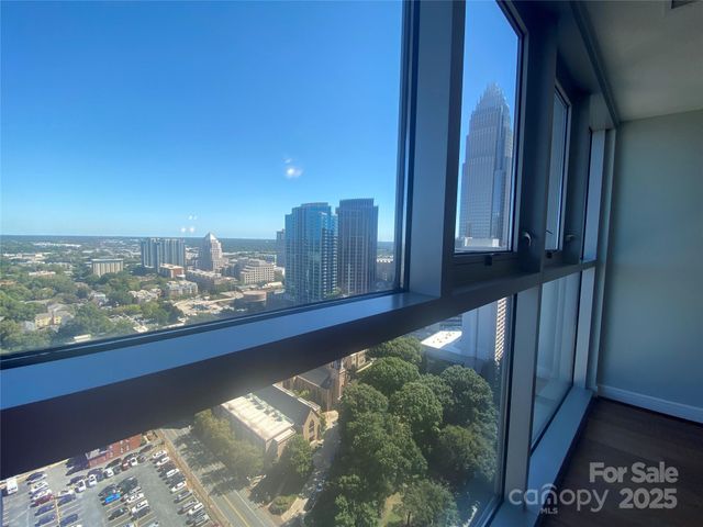 a kitchen with granite countertop a stove and a large window