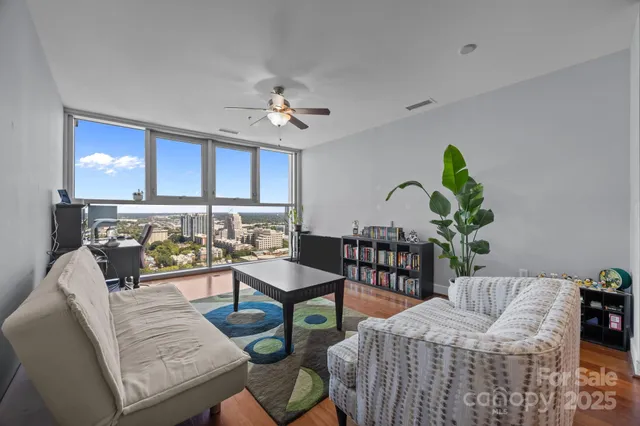 a living room with furniture and a potted plant