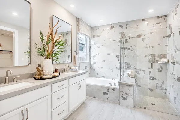 a bathroom with a double vanity sink toilet and shower
