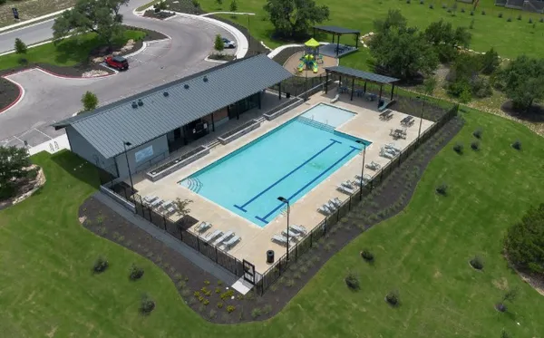 a view of a big yard with swimming pool and outdoor seating