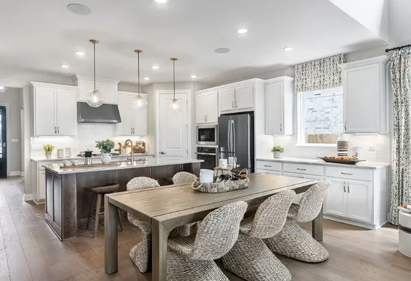 a kitchen with granite countertop a sink cabinets and refrigerator
