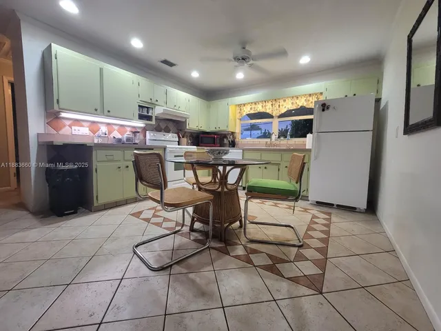 a kitchen with stainless steel appliances a sink a counter top space and cabinets