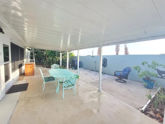 a outdoor space with a large window and sitting area