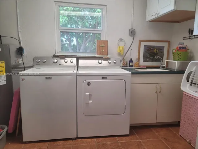 a view of a kitchen with sink and window