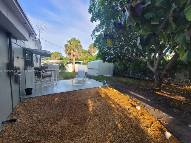 a view of a porch with dining table and chairs