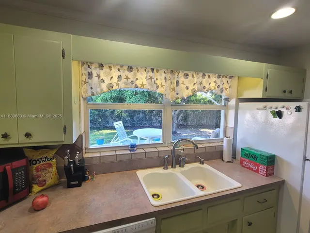 a bathroom with a sink mirror and window