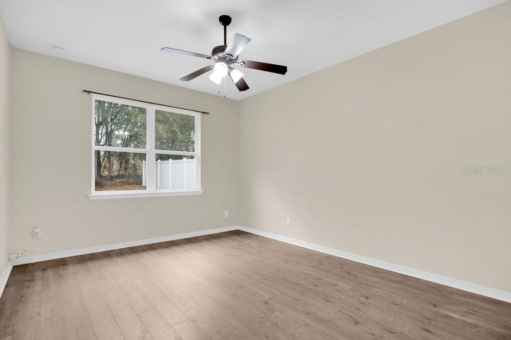 680 Preakness Circle Deland, FL 32724 - Photo 17 of 28 a view of an empty room with wooden floor and a window