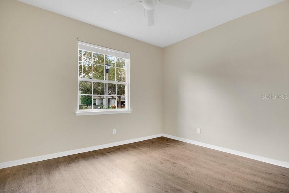 680 Preakness Circle Deland, FL 32724 - Photo 19 of 28 wooden floor in an empty room with a window