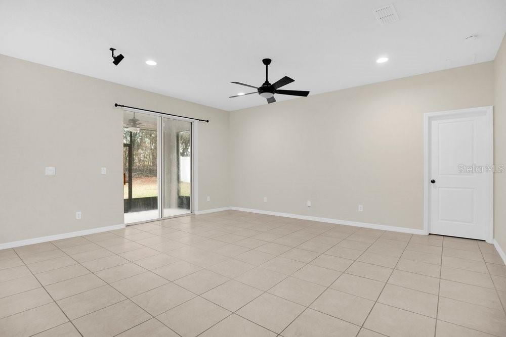 680 Preakness Circle Deland, FL 32724 - Photo 5 of 28 wooden floor in an empty room with a window