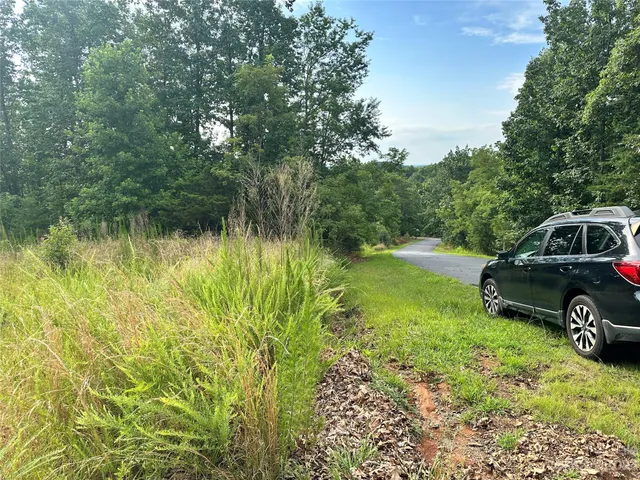 a view of a backyard with a car parked in it
