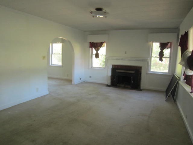 2552 Anderson Drive Macon, GA 31206 - Photo 2 of 12 an empty room with a fireplace and windows