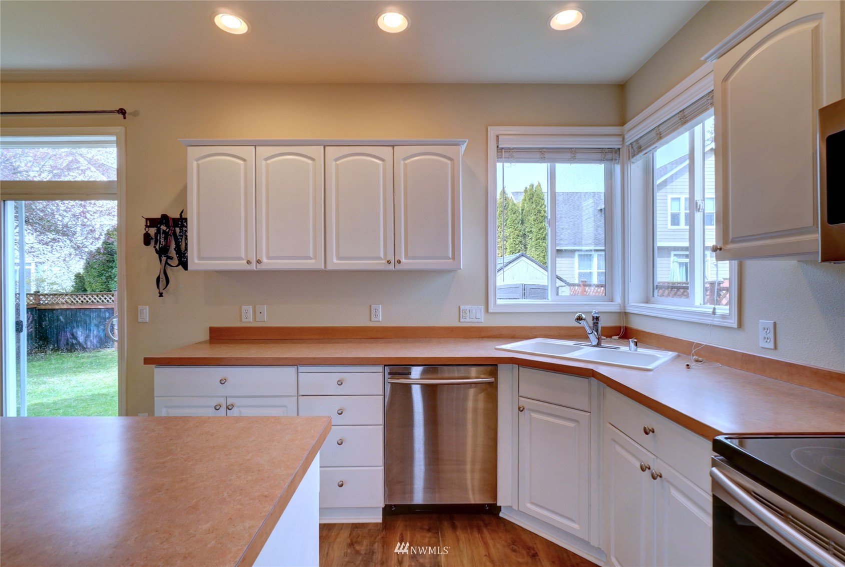 7053 Radius Loop Southeast Lacey, WA 98513 - Photo 11 of 34 a kitchen with a sink stove and cabinets