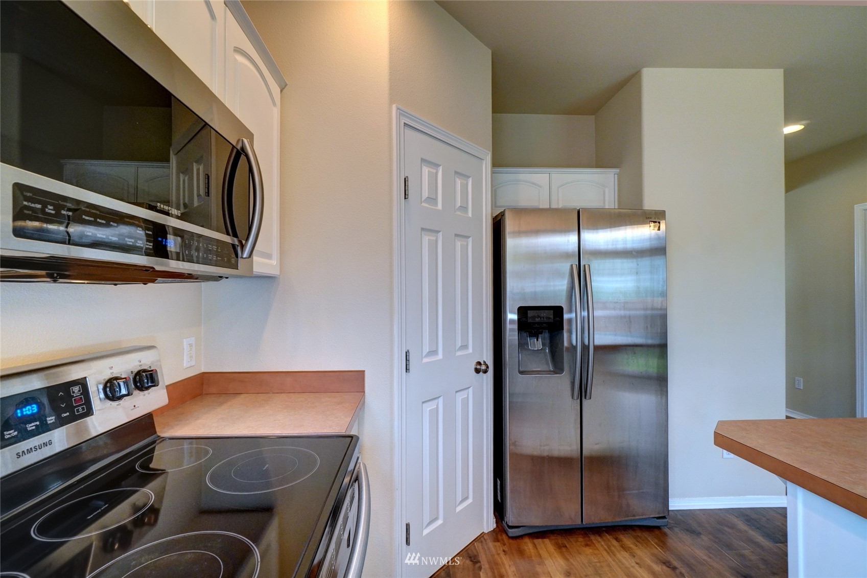 7053 Radius Loop Southeast Lacey, WA 98513 - Photo 12 of 34 a kitchen with stainless steel appliances granite countertop a refrigerator and a stove top oven