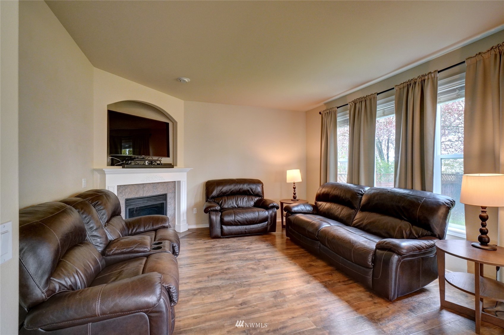 7053 Radius Loop Southeast Lacey, WA 98513 - Photo 15 of 34 a living room with furniture a flat screen tv and a fireplace