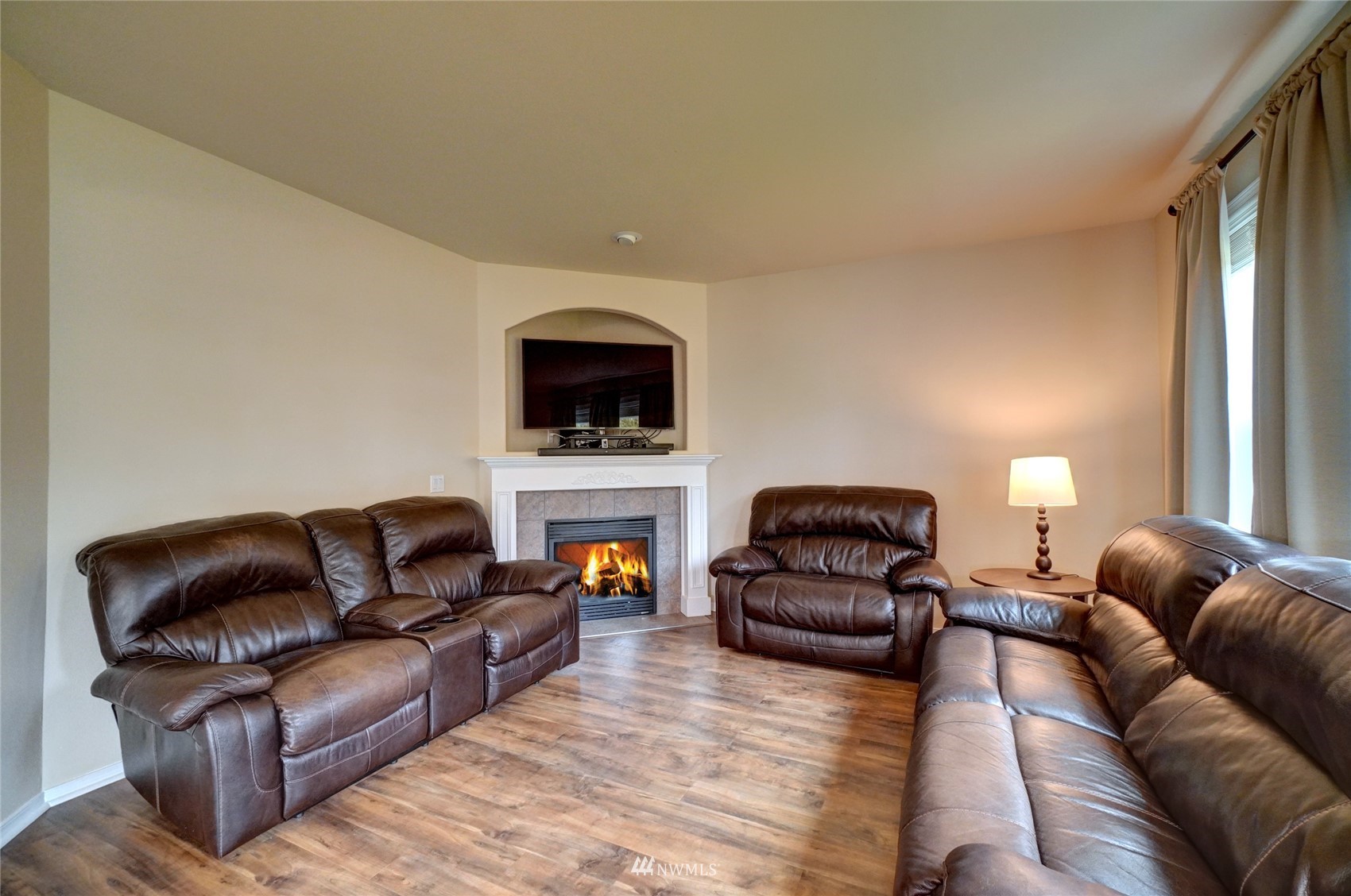 7053 Radius Loop Southeast Lacey, WA 98513 - Photo 16 of 34 a living room with furniture a fireplace and a flat screen tv