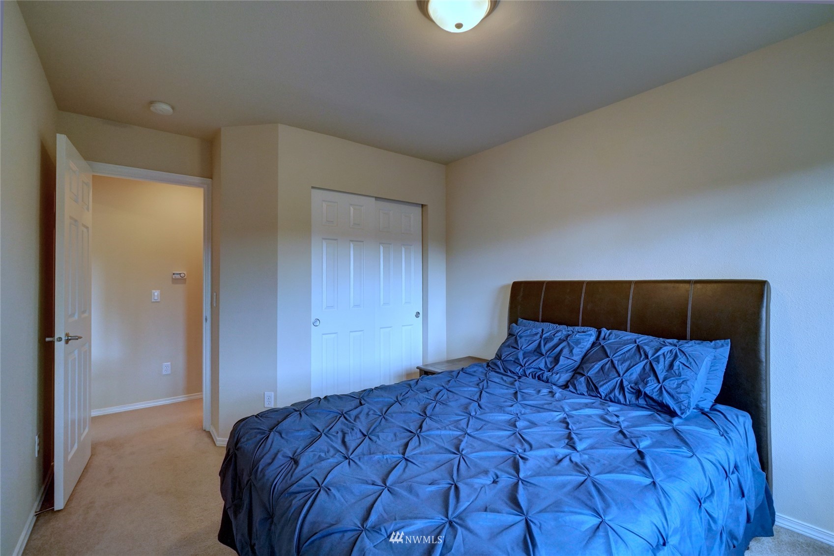 7053 Radius Loop Southeast Lacey, WA 98513 - Photo 28 of 34 a bedroom with a large bed and a closet