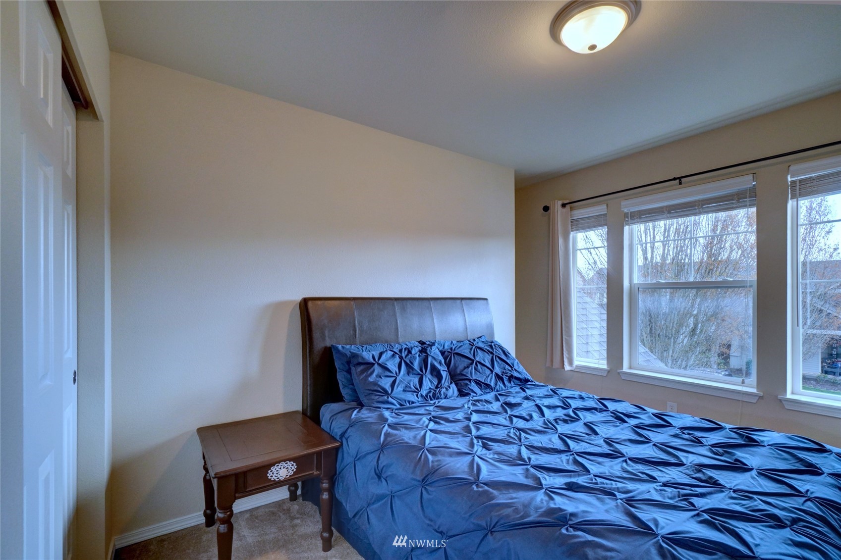 7053 Radius Loop Southeast Lacey, WA 98513 - Photo 29 of 34 a large bed sitting in a bedroom next to a window