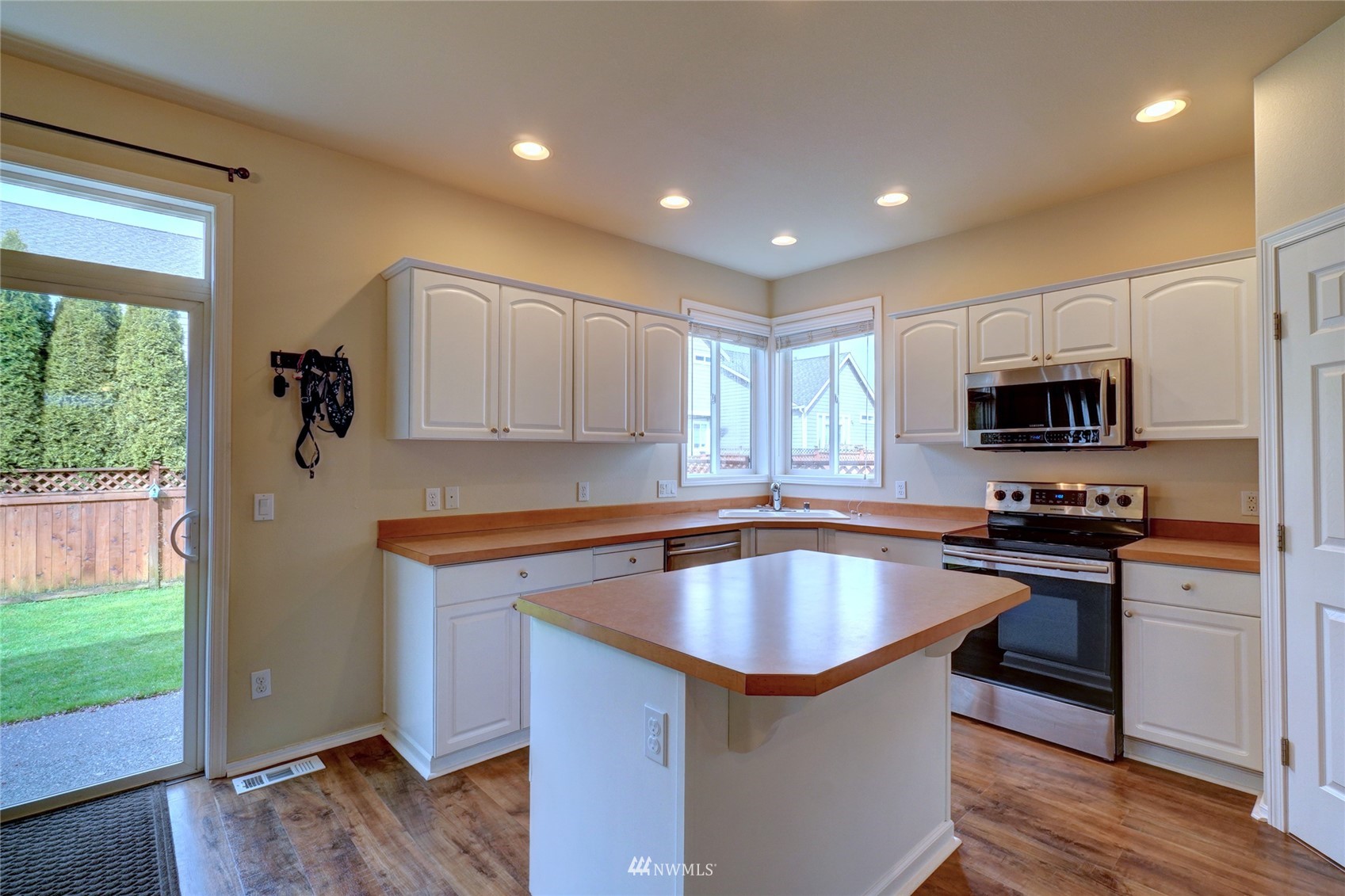 7053 Radius Loop Southeast Lacey, WA 98513 - Photo 9 of 34 a kitchen with stainless steel appliances granite countertop a sink a stove and microwave