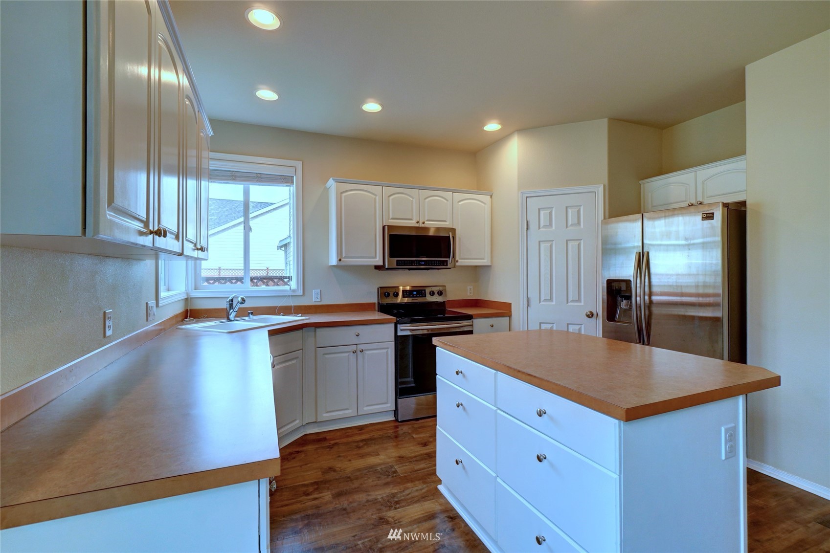 7053 Radius Loop Southeast Lacey, WA 98513 - Photo 10 of 34 a kitchen with stainless steel appliances granite countertop a sink stove and refrigerator