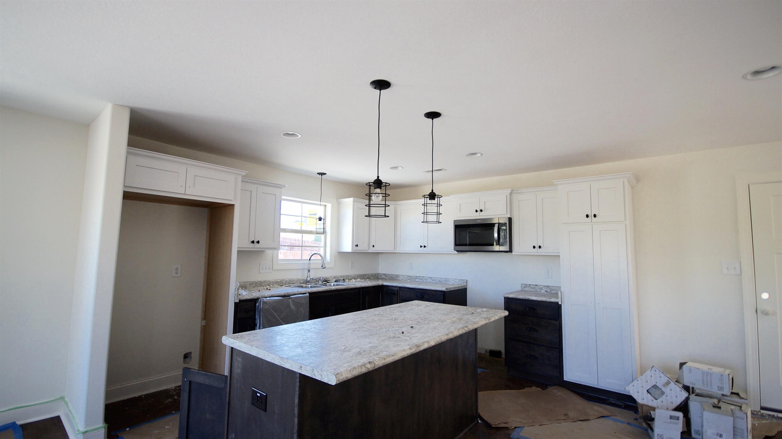 3568 Drake Road Adams, TN 37010 - Photo 5 of 6 a kitchen with kitchen island a sink stove and refrigerator