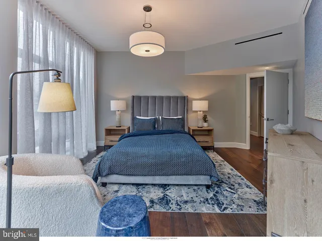 a bedroom with a bed dresser and a large mirror