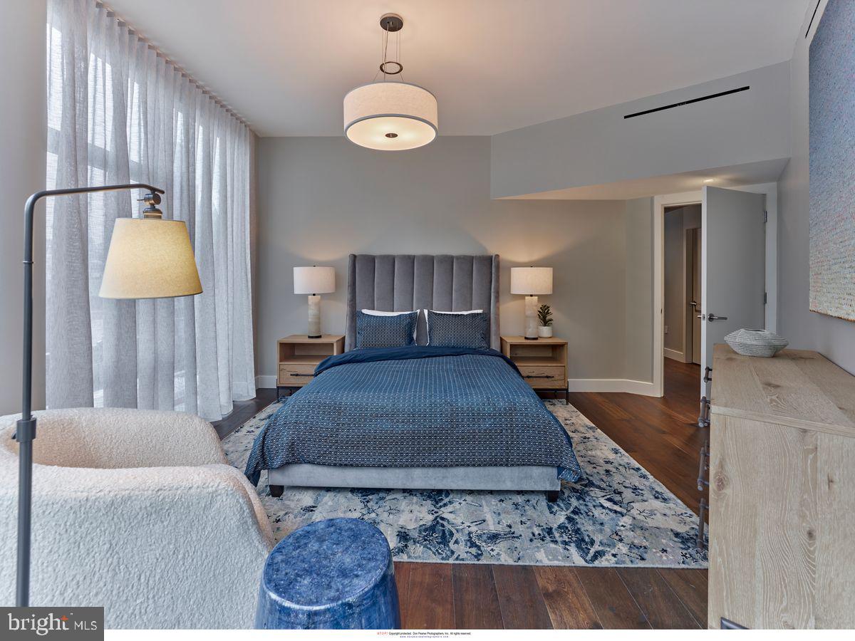 2100 Hamilton Street, Unit 9D Philadelphia, PA 19130 - Photo 17 of 24 a bedroom with a bed dresser and a large mirror