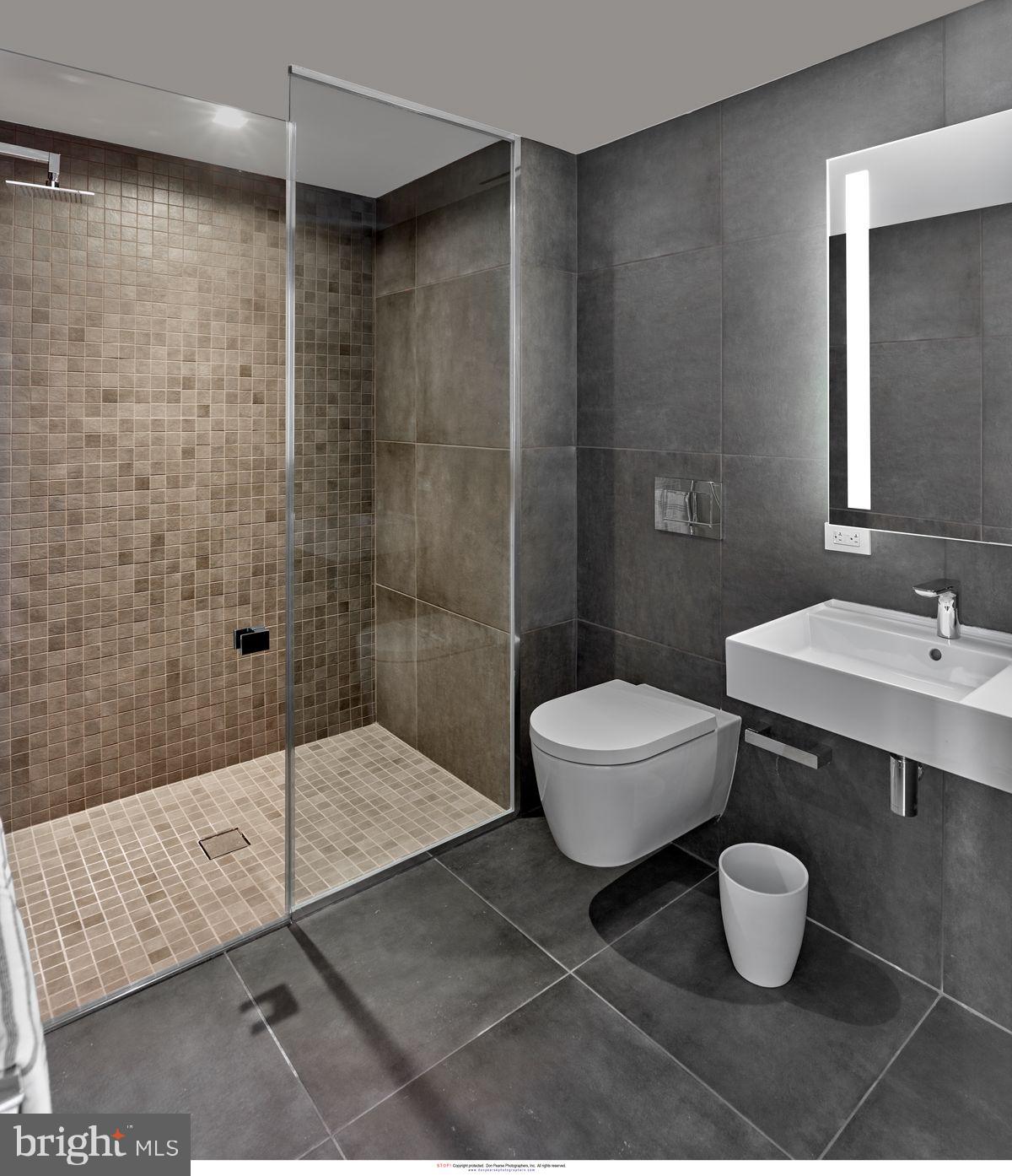 2100 Hamilton Street, Unit 9D Philadelphia, PA 19130 - Photo 24 of 24 a bathroom with a bathtub shower sink and toilet