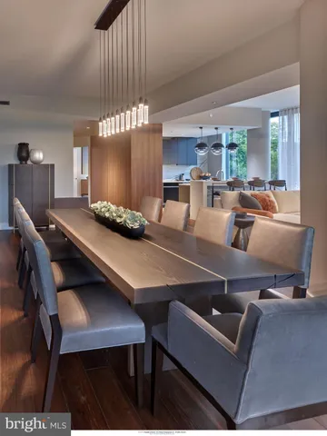 a kitchen with a table chairs and a projector screen