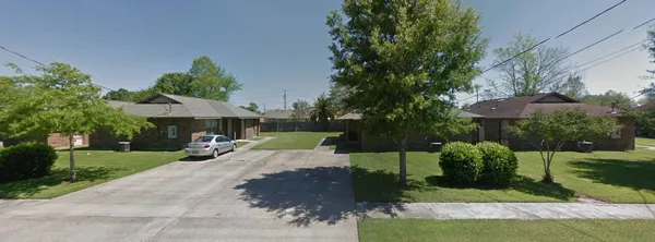 a view of a house with backyard and a tree