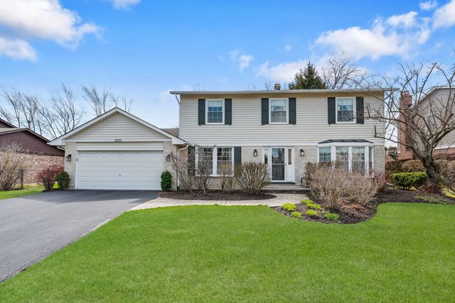 a view of a house with a yard and sitting area