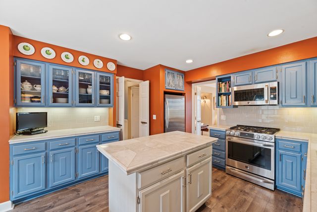 a kitchen that has a stove and a microwave