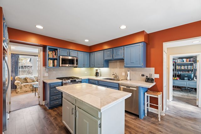 a kitchen with a stove a sink and a refrigerator