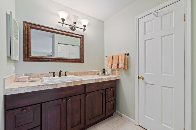 a bathroom with a sink vanity and mirror