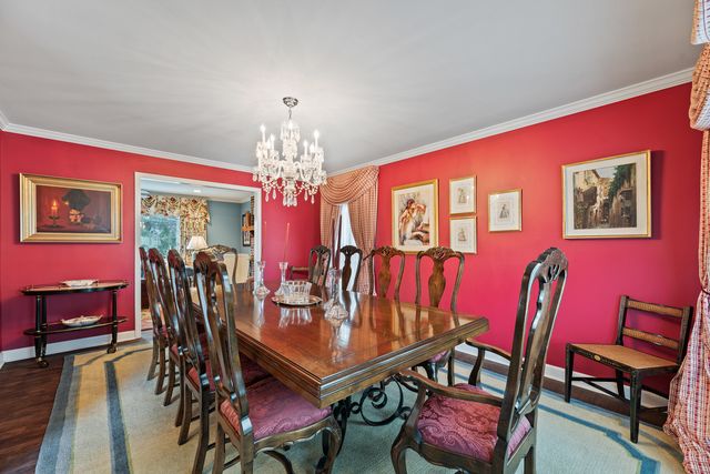 a view of a dining room with furniture and chandelier