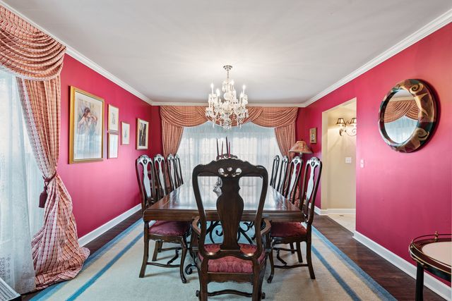 a view of a dining room with furniture and chandelier