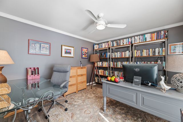 a living room with furniture cabinets and book shelf