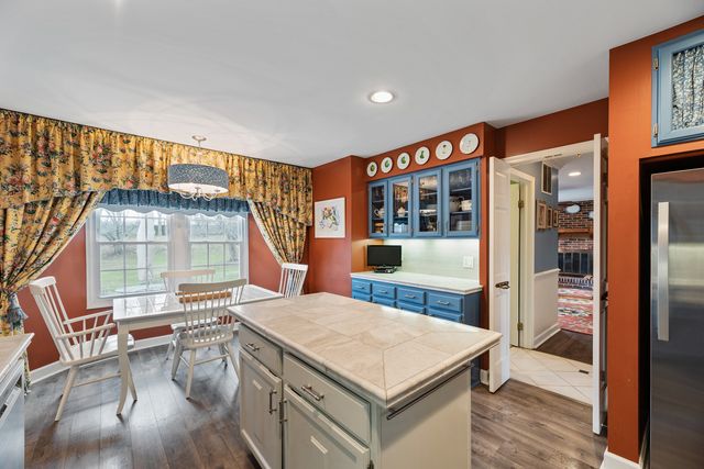 a living room with furniture a flat screen tv and a floor to ceiling window