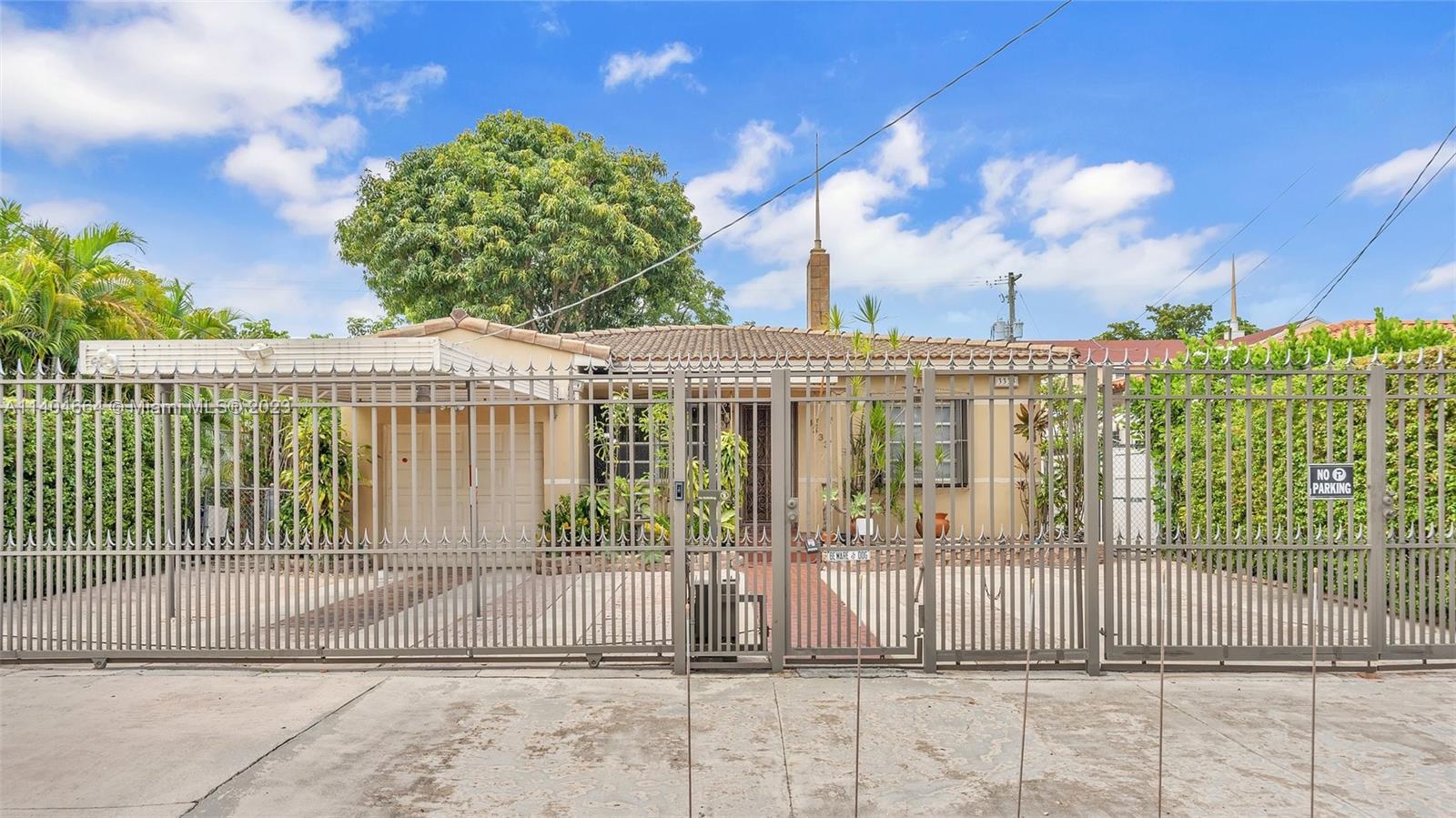 a view of a brick house next to a yard